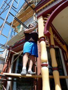 My husband painting our Queen Anne Victorian. Photo credit Charlie Trentleman