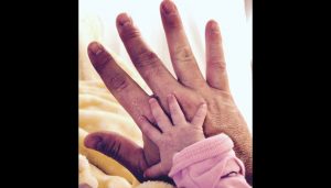 Remembering my dad on his birthday - photo of a dad's hand with a chubby infant girl's hand