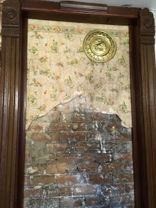 Wallpaper and chimney brick we found behind a false wall in our kitchen.