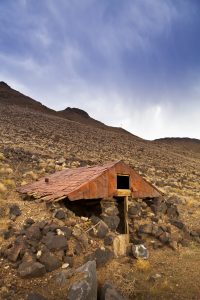 An abandoned dugout like the one the Isaac Behunin family would have spent their first winter in.