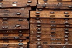 Old wooden file drawers - Services like TranscribeMe sure beat the old methods.