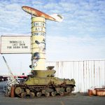 Bert Smith who founded Smith and Edwards told about a time when he almost died in an accident. Photo of the tank and sign outside Smith and Edwards. 