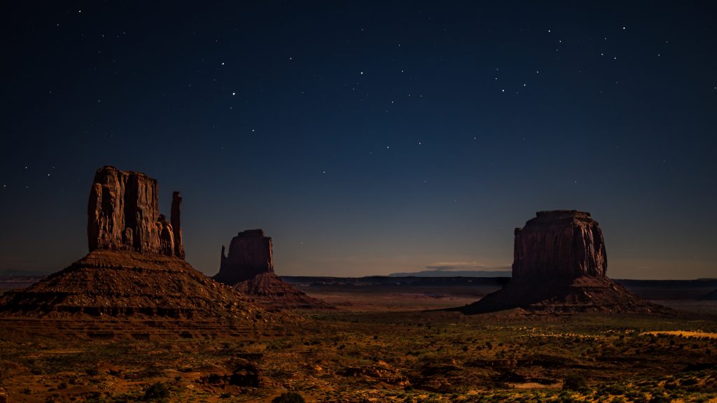 Photo credit: nico-kramer-450511-unsplash. A nighttime photo near \the 4-corners area where Laura Hedgecock had a powerful experience listening to stories