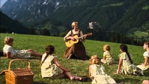 The Sound of Music screen shot - Maria sings do re mi with the Von Trapp children up in the hills