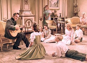 Story structure example: Captain Von Trapp from the Sound of Music sings to Edelweiss to his children. This scene is nearing the midpoint of the movie where all the loves are coming together: family, country, and music. Maria stands in the background, not quite invited into the circle yet. 