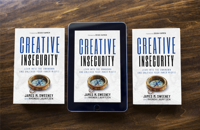 Creative Insecurity by James M. Sweeney and Rhonda Lauritzen. 2 print copies and the ebook on a tablet sitting on a wooden tabletop