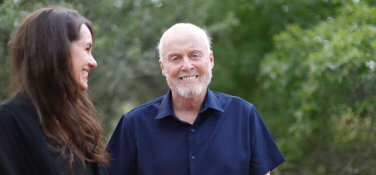 Remembering James M. Sweeney: Jim Sweeney and co-author Rhonda Lauritzen standing outside by trees