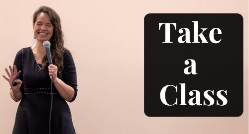 Take a class: Rhonda Lauritzen speaking at a conference with a mic in her hand, laughing, eyes squinted closed